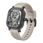 Luxury skeleton watch with carbon fiber case, beige rubber strap, and visible tourbillon, inspired by motorsport design.