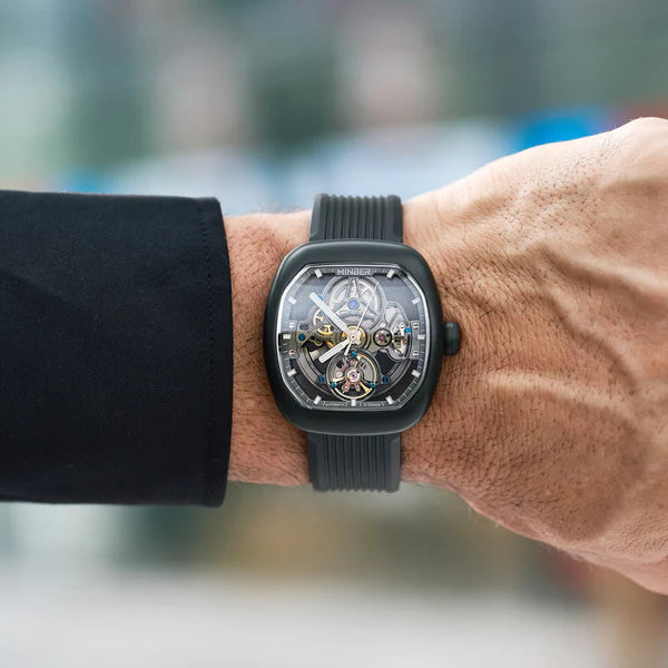 Luxury skeleton watch with bold square case, carbon fiber accents, and sport-luxury design on wrist