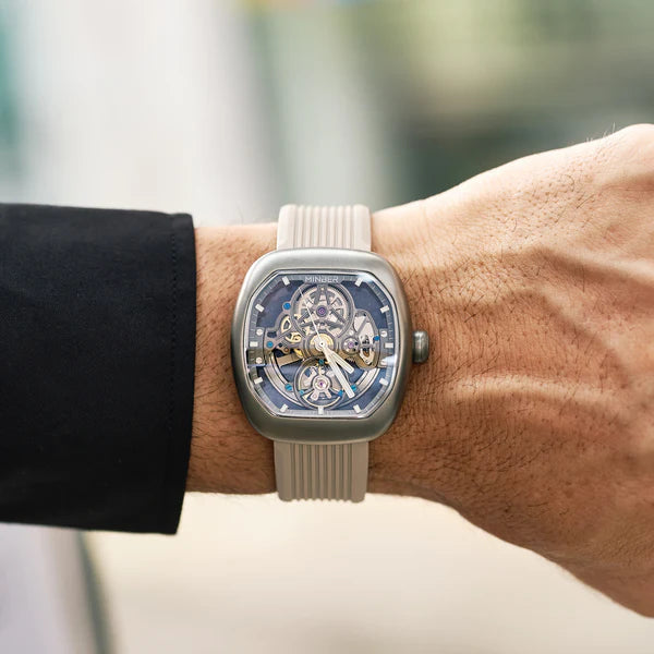 Luxury skeleton watch with blue dial, carbon fiber case, and sporty strap — motorsport-inspired design