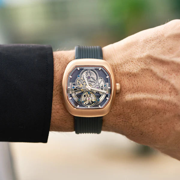 Luxury skeleton watch with rose gold case and black strap, inspired by high-performance motorsport design