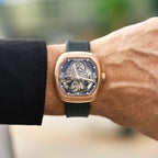 Luxury skeleton watch with rose gold case and black strap, inspired by high-performance motorsport design
