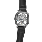 Luxury skeleton watch with exposed mechanical movement, carbon fiber case, and 20mm rubber strap — motorsport-inspired design.