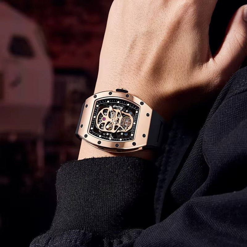 Luxury motorsport-inspired skeleton watch with rose gold case and black strap on wrist