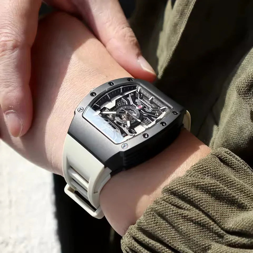 Skeleton dial homage sport-luxury watch with black case and white band on wrist