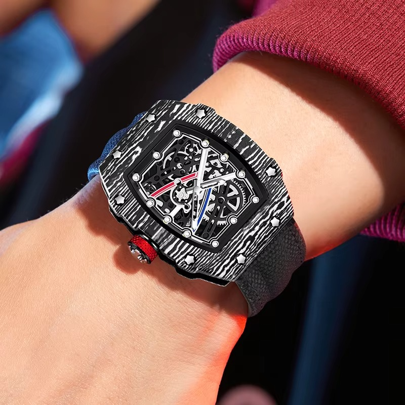 Carbon fiber skeleton watch with bold motorsport design, red crown, and sport-luxury style on wrist