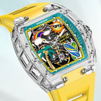 Luxury sport-inspired watch with clear case, bold yellow strap, and playful tropical dial elements
