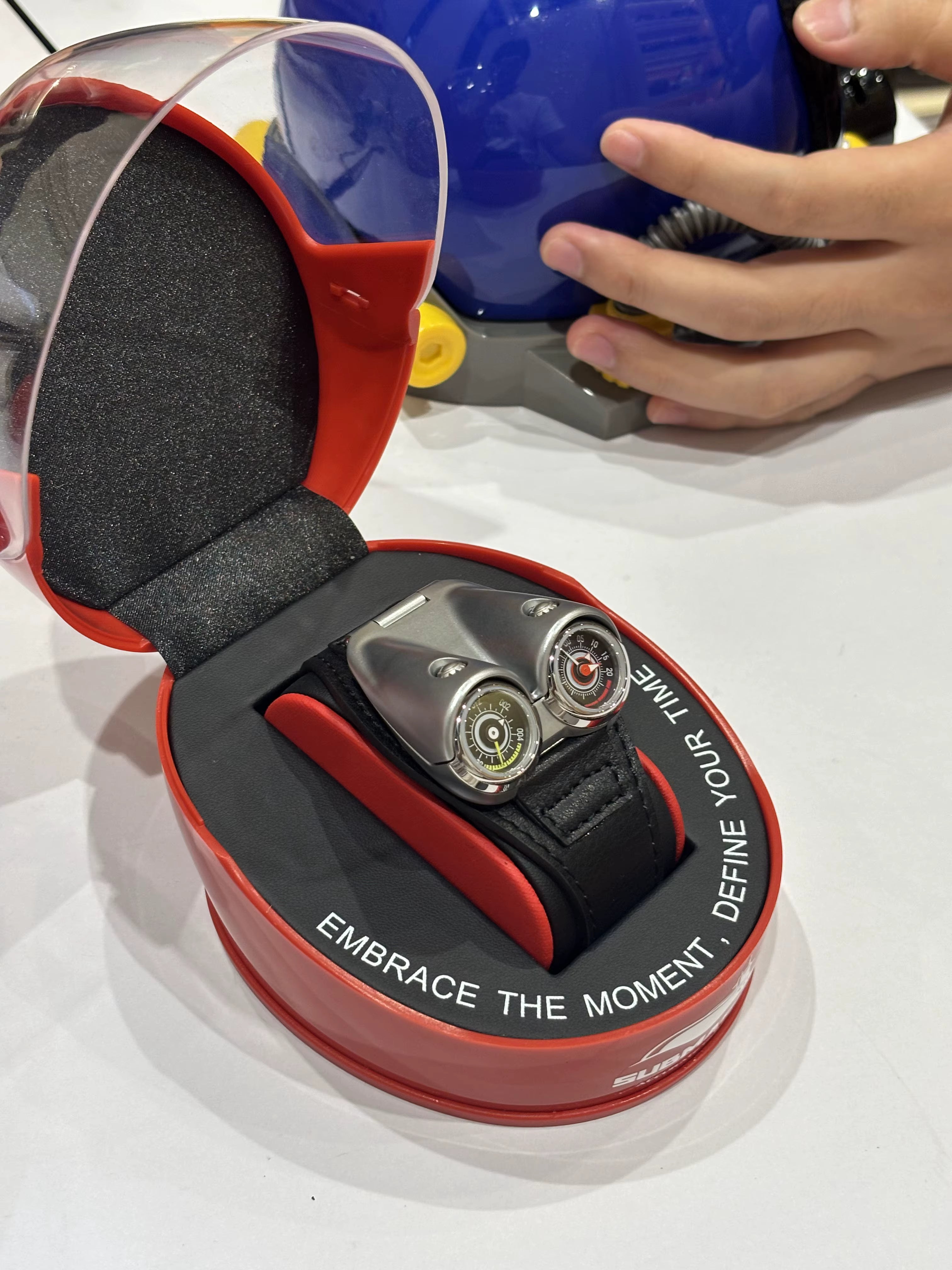 Motorsport-inspired dual-dial luxury watch in red display case with bold, modern design