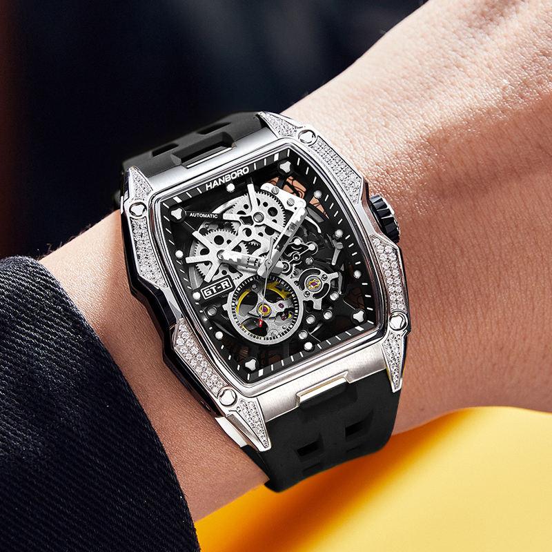 Luxury motorsport-inspired skeleton automatic watch with black rubber strap on wrist