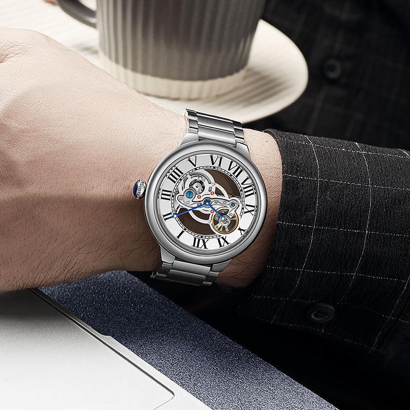 Luxury sport-inspired skeleton watch with Roman numerals and stainless steel bracelet on wrist