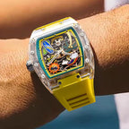 Motorsport-inspired luxury watch with clear case, yellow band, and colorful dial details on wrist