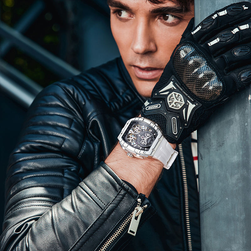 Motorsport-inspired luxury watch with white band and skeleton dial on man's wrist in racing glove