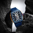 Blue and gold racing-inspired luxury watch with skeleton dial, sporty strap, bold design