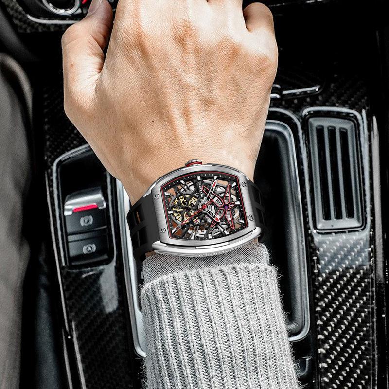 Luxury motorsport-inspired skeleton watch with bold case design on wrist in car interior