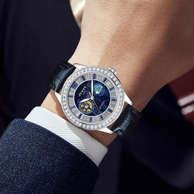 Luxury sport-inspired wristwatch with blue starry dial, diamond bezel, and black leather strap.