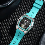 Luxury sport-inspired turquoise skeleton watch with tonneau case and openwork dial on mesh background