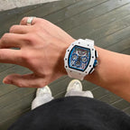 White tonneau-shaped motorsport-inspired luxury watch with openwork dial on wrist
