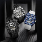 Trio of luxury skeleton dial sport watches with square cases and rubber straps on black surface