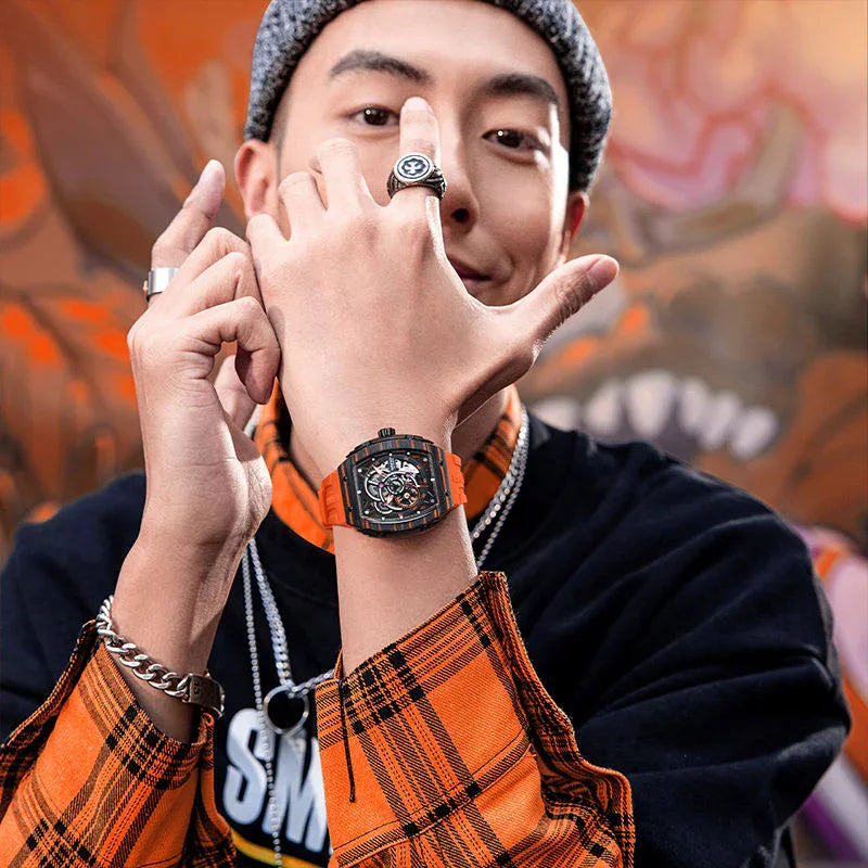 Man wearing motorsport-inspired luxury watch with orange strap and skeleton dial, urban style