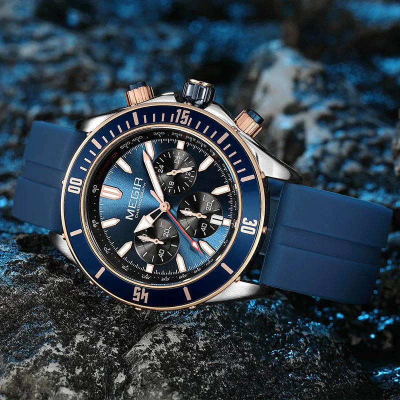 Blue chronograph sport-luxury racing watch with bold dial, rose gold accents, rubber strap