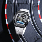 Luxury motorsport-inspired skeleton watch with white strap, black case, and racing track backdrop