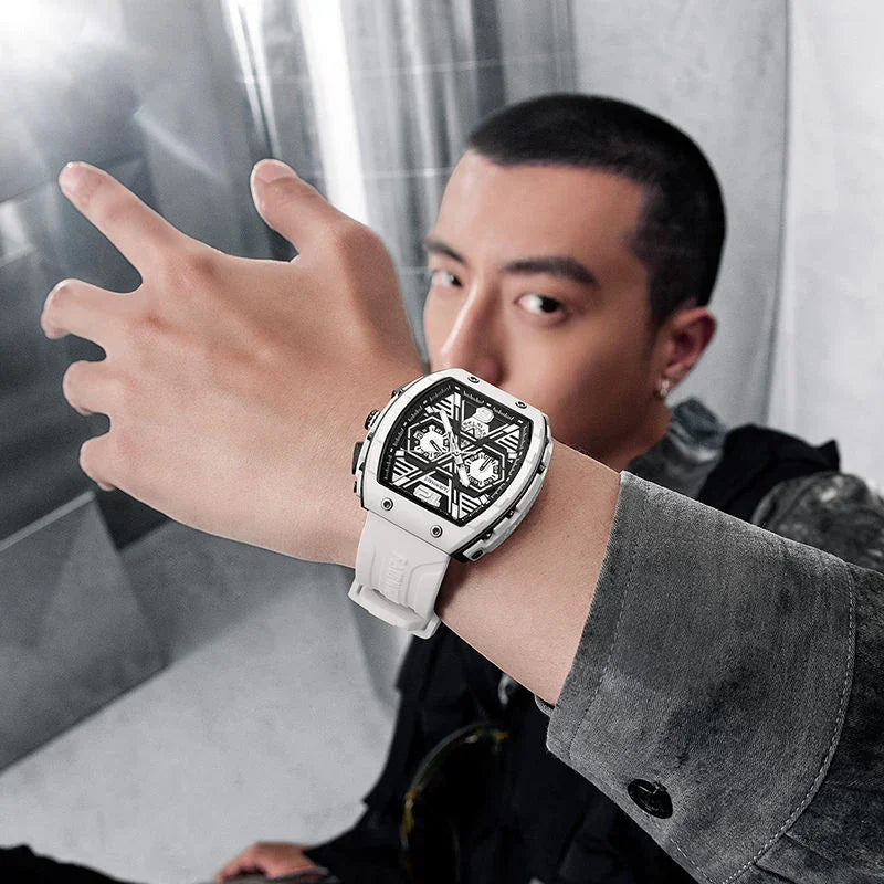 Man wearing a modern racing-inspired white watch with a skeleton dial and bold design.