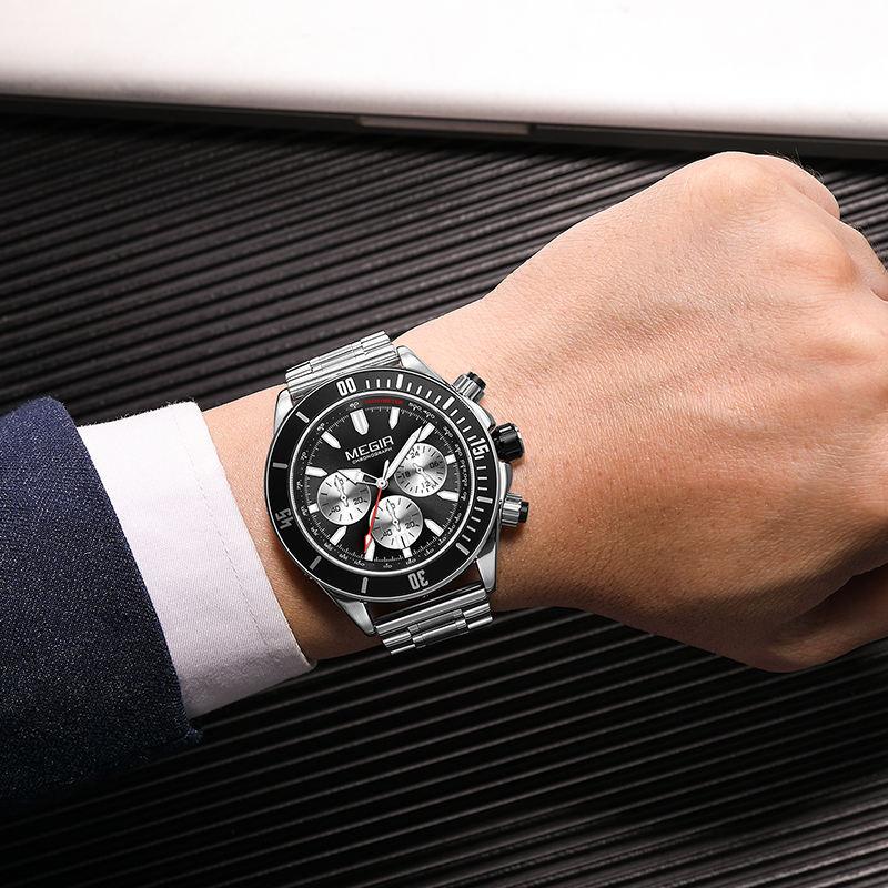Luxury motorsport-inspired chronograph watch with black dial and metal band on wrist