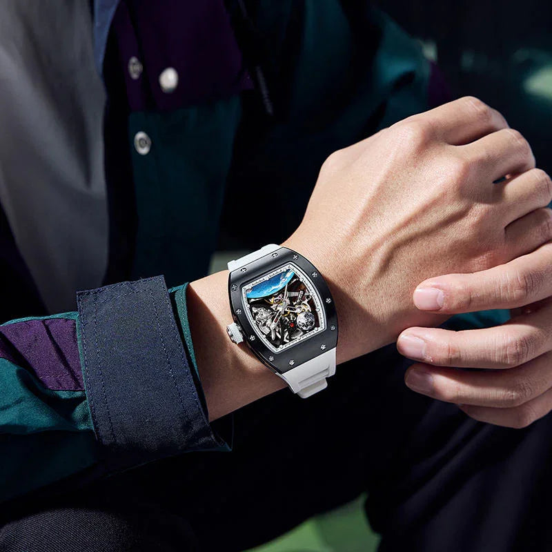 Luxury motorsport-inspired skeleton watch with white strap and bold tonneau-shaped case on wrist