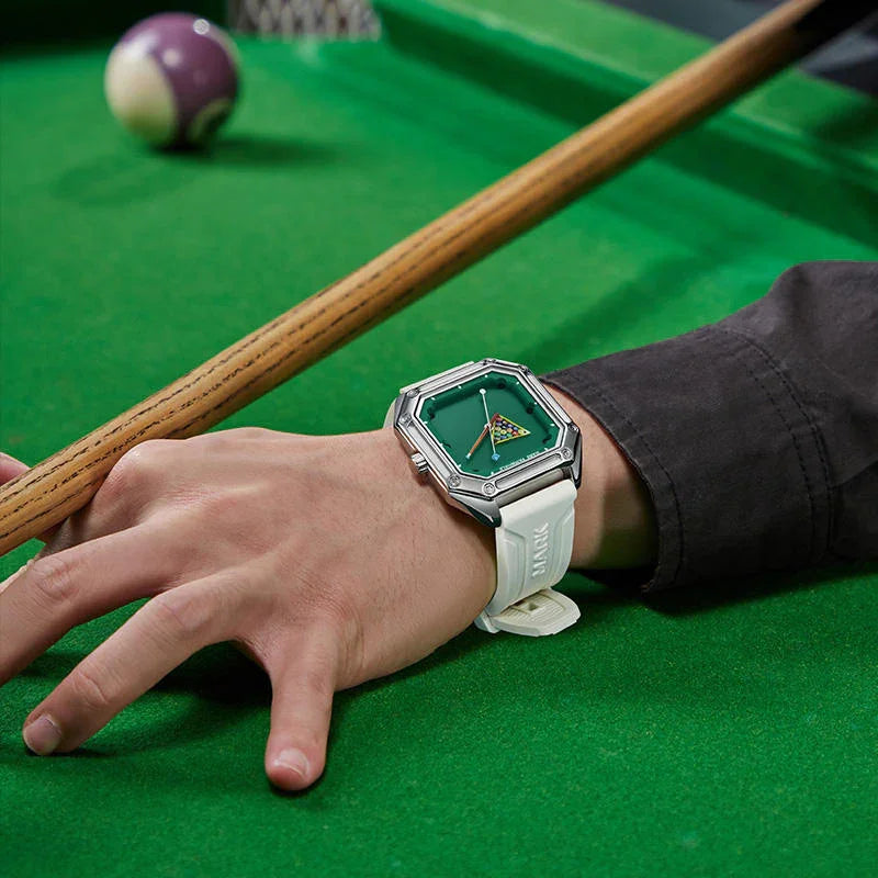 Luxury sport-inspired green dial watch with white strap worn at billiards table