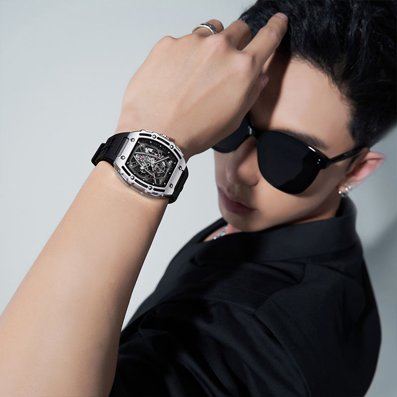 Man wearing luxury skeleton sport watch with black strap, motorsport-inspired design