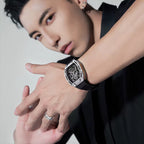 Man modeling a luxury sport-inspired skeleton dial watch with a black rubber strap
