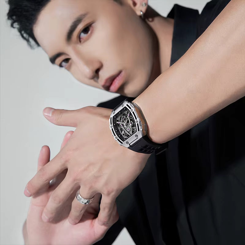 Man modeling a luxury sport-inspired skeleton dial watch with a black rubber strap