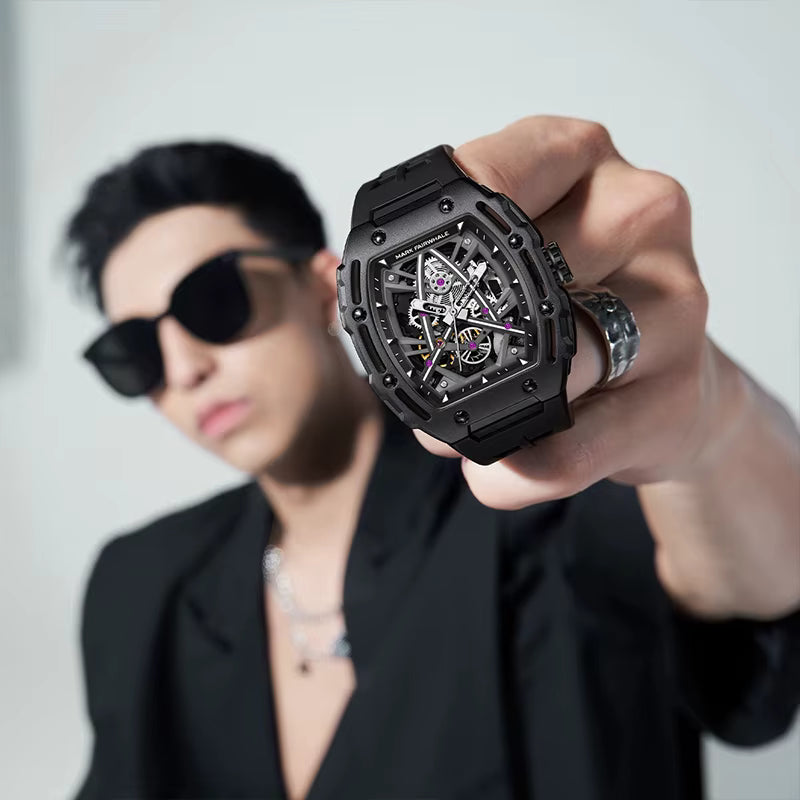 Man holding bold skeleton dial sport-luxury watch with black case, motorsport-inspired design