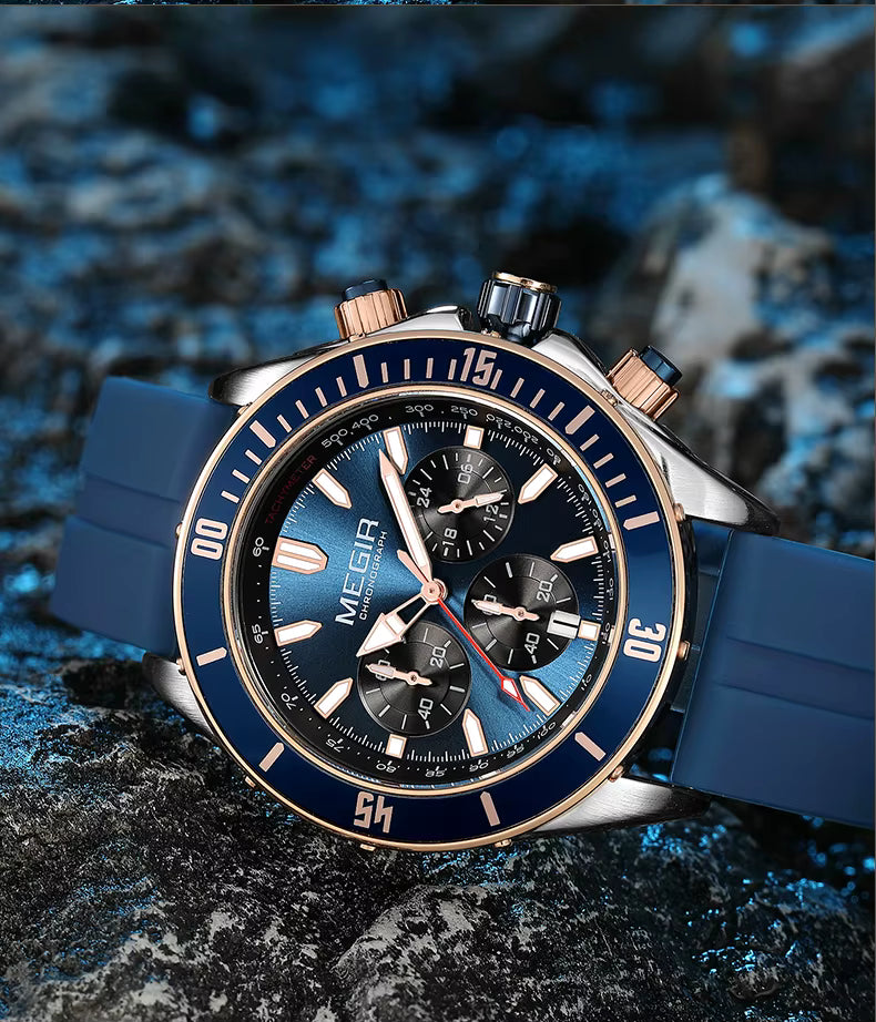 Blue sport chronograph watch with bold dial and rose gold accents on textured rock background