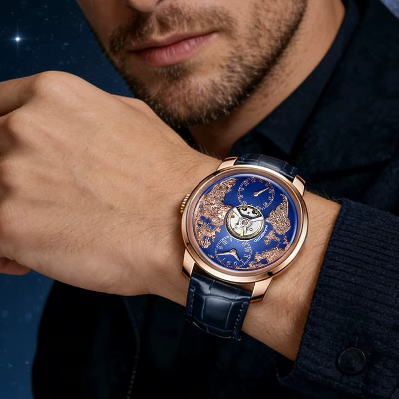 Man wearing a blue and gold luxury homage watch with open-heart dial and world map design.